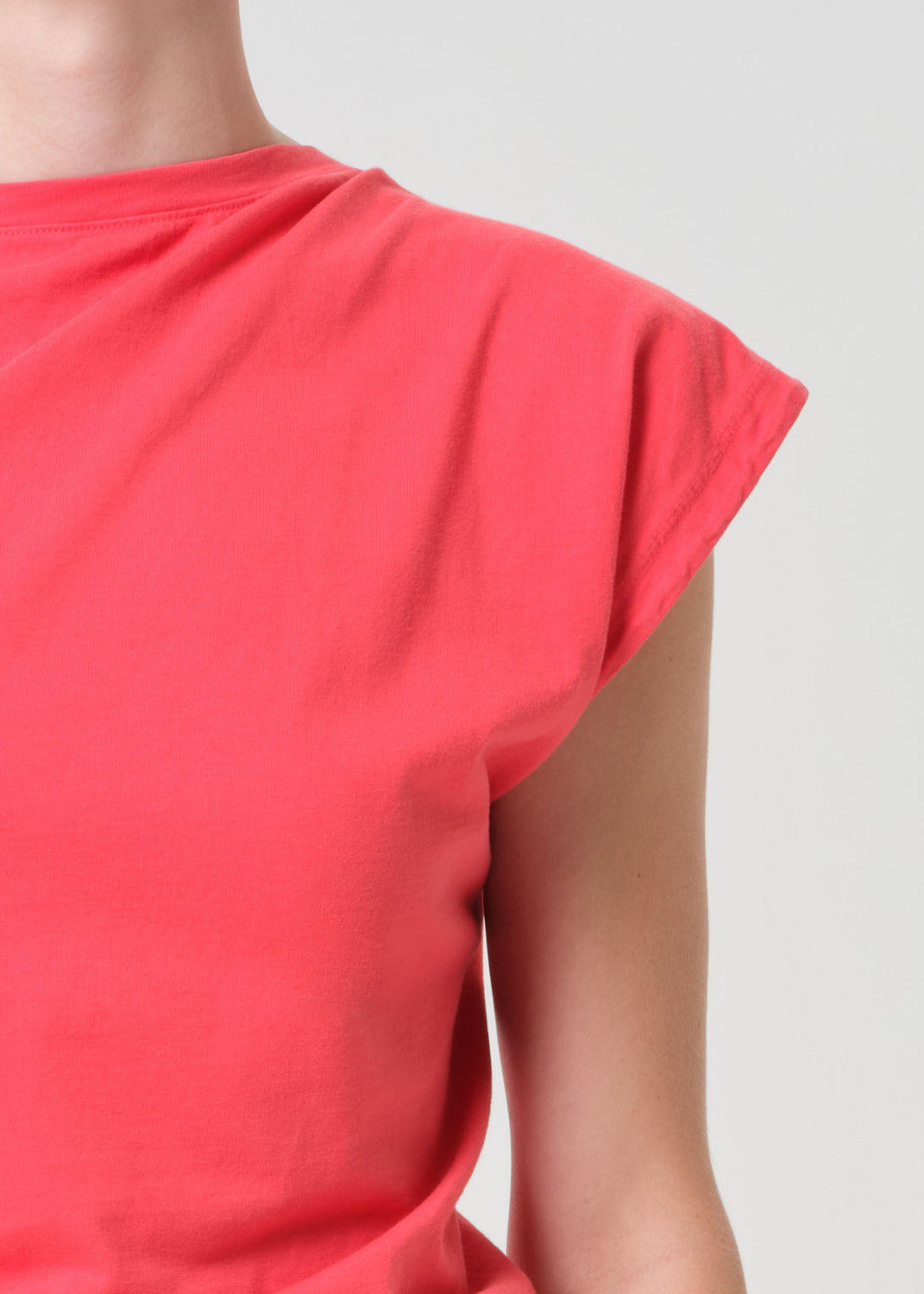 Red sleeveless top on a plain background