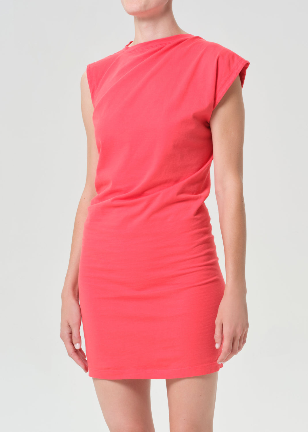Coral dress worn by a person on a plain background