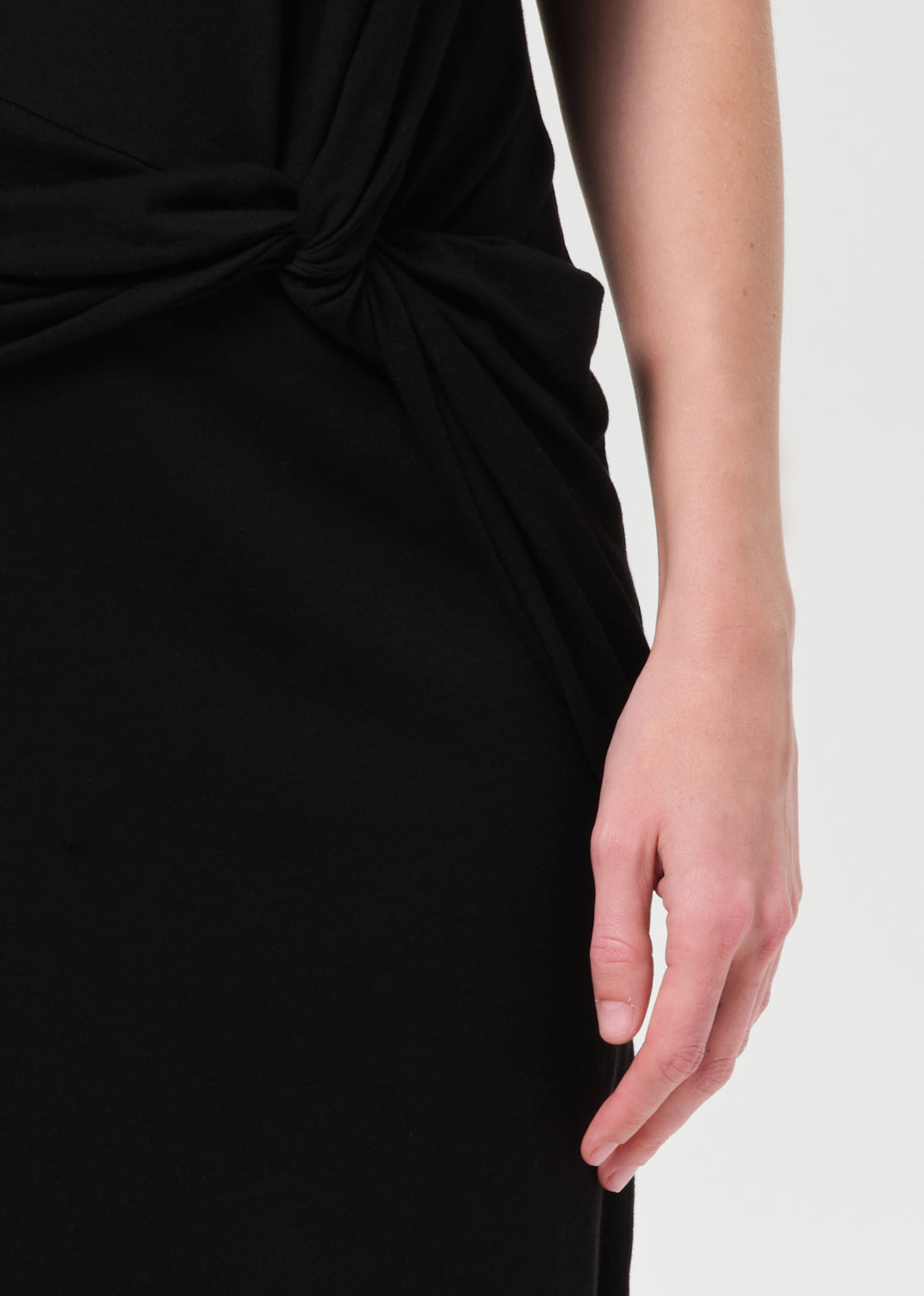 Black dress with a knot detail on a white background