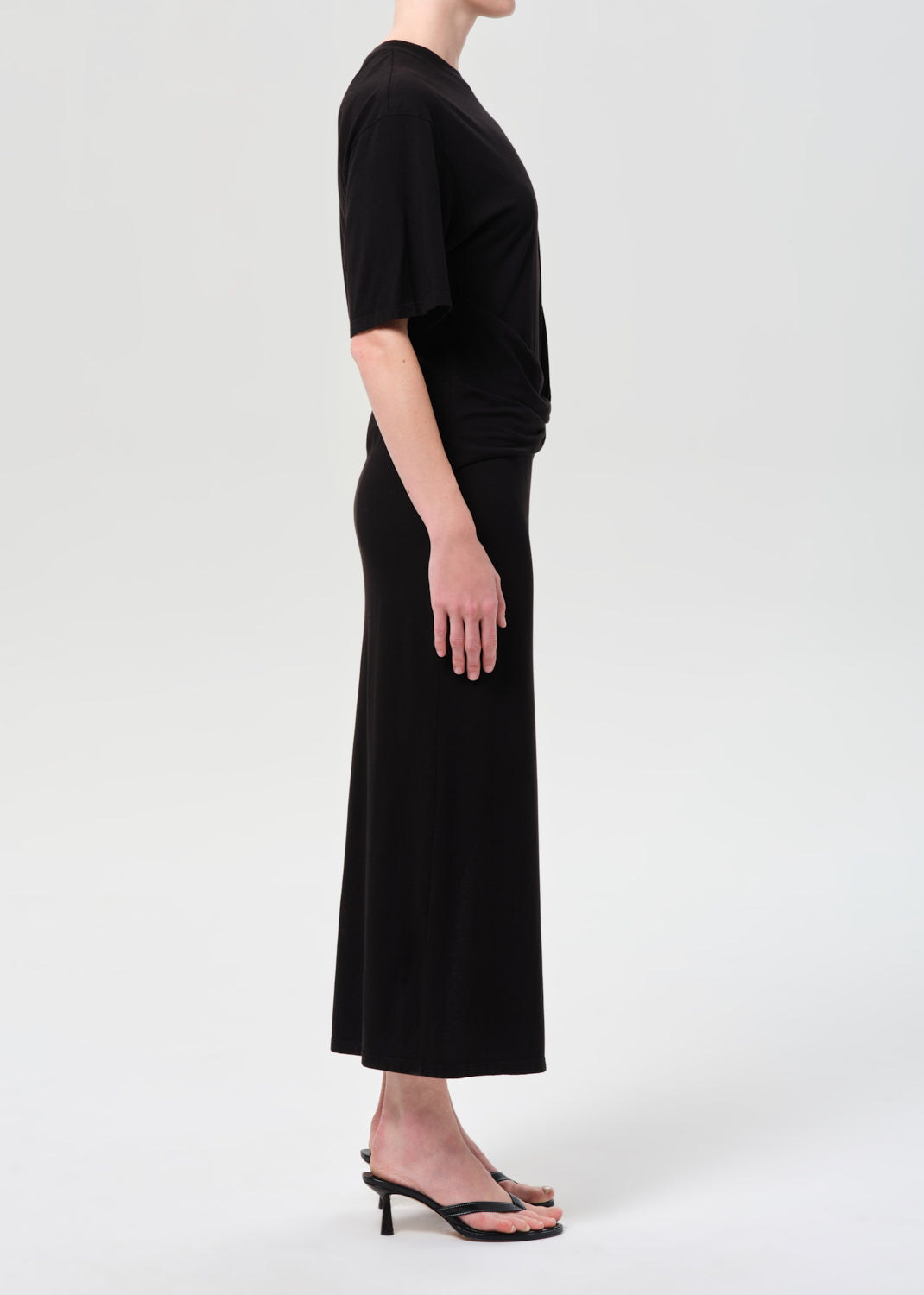 Person wearing a black dress on a white background