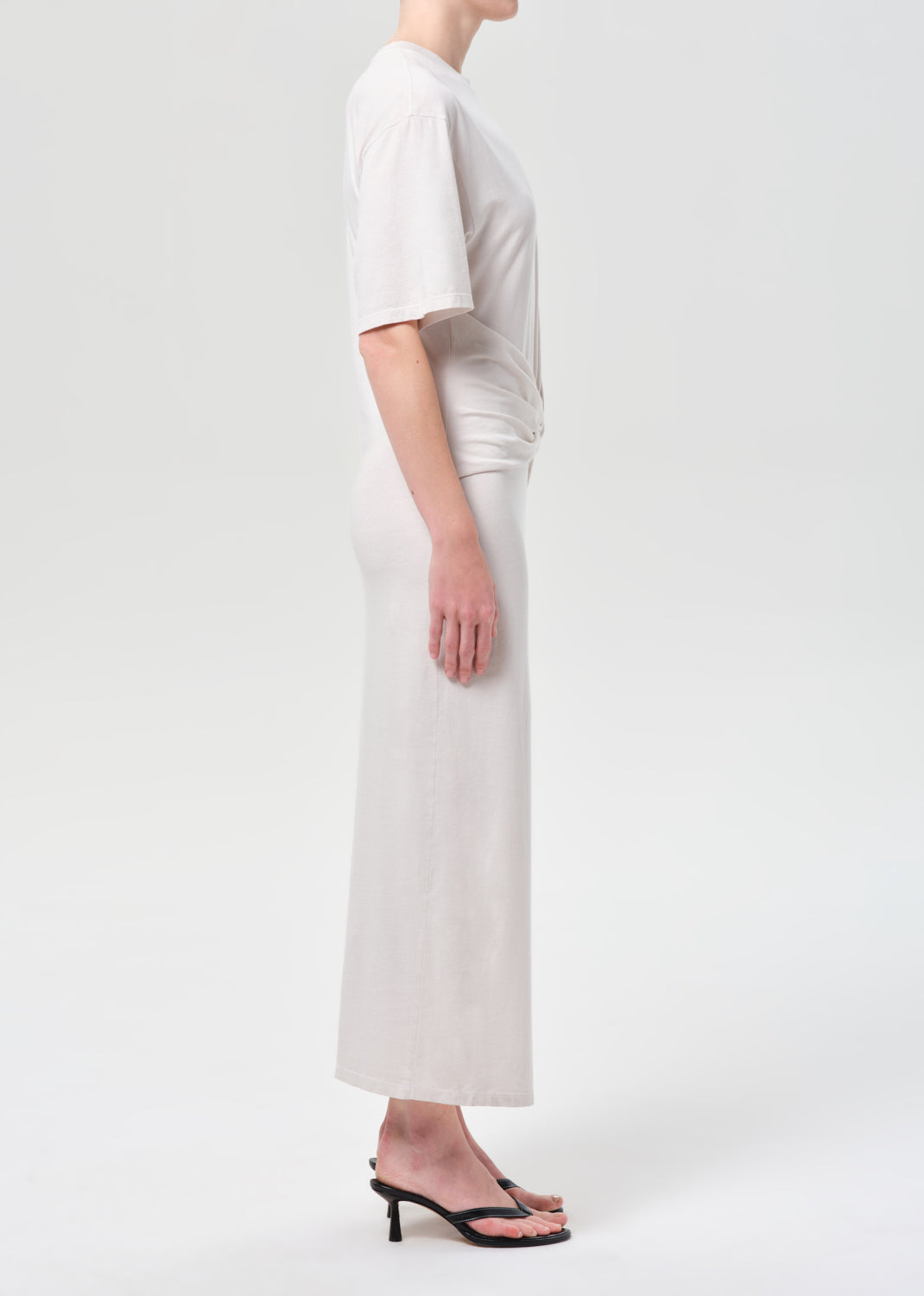 Person wearing a white outfit on a plain background