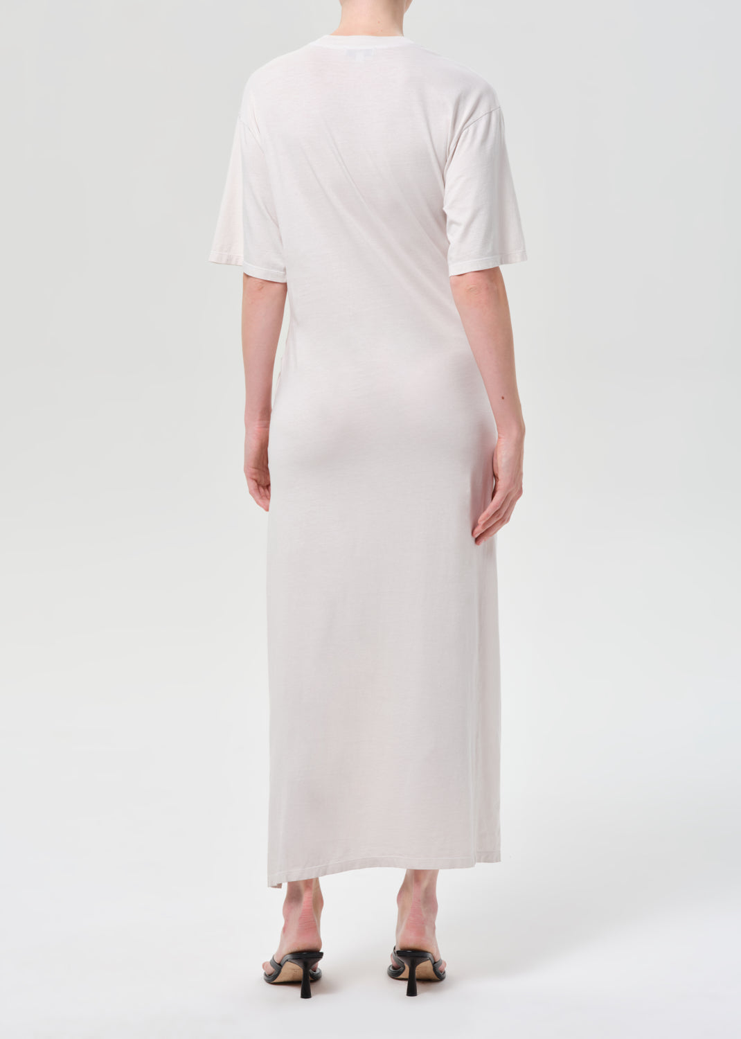 Person wearing a white dress on a white background