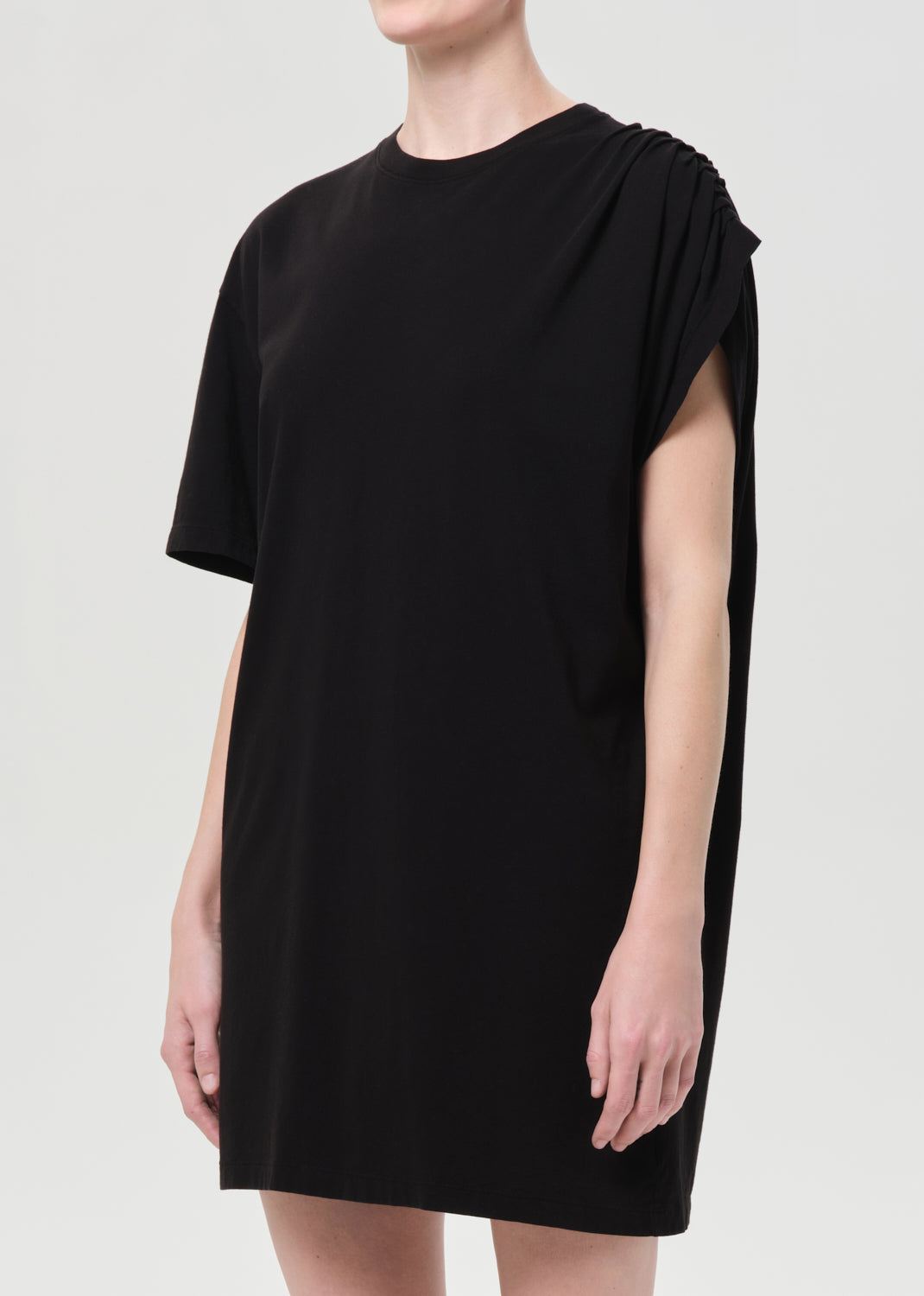Black dress worn by a person on a white background