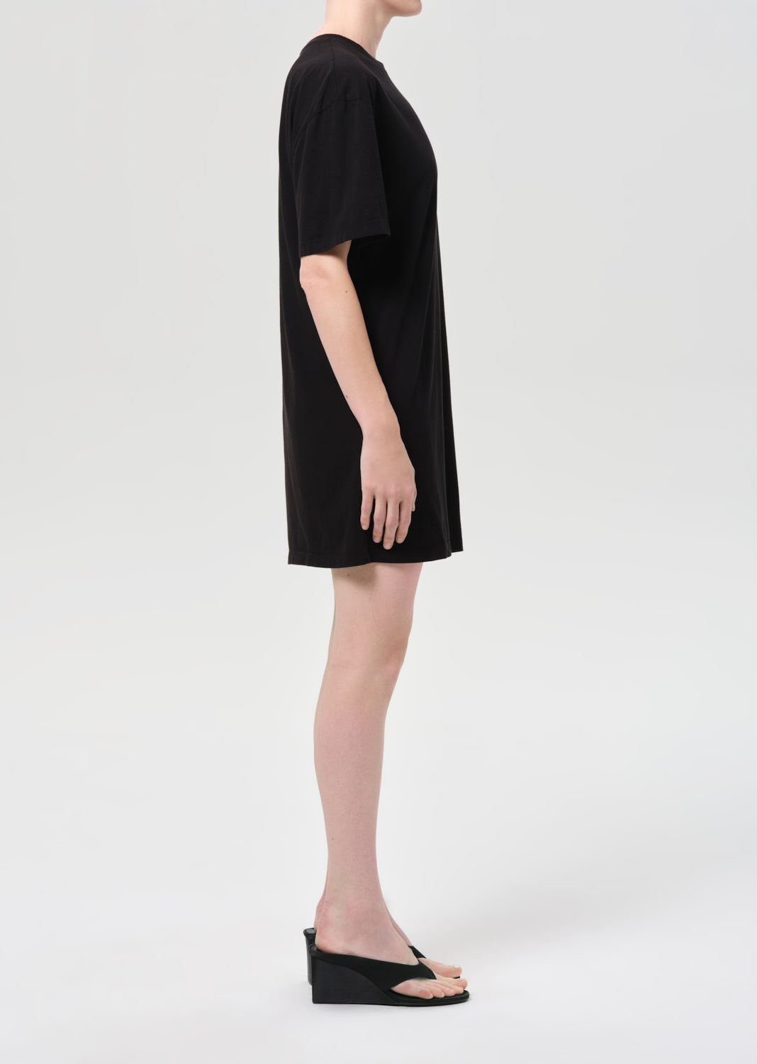 Person wearing a black dress on a white background