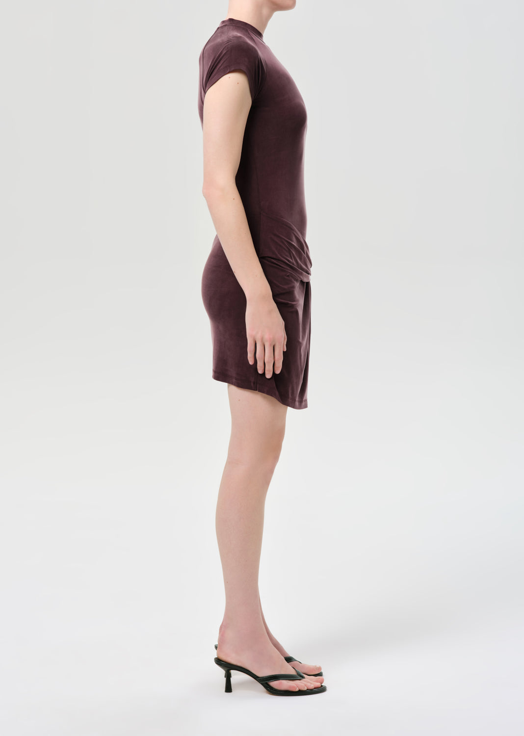 Woman wearing a brown dress on a white background