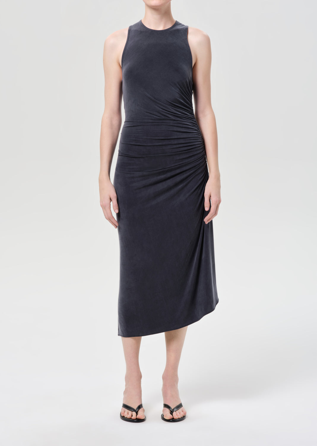 Woman wearing a sleeveless black dress on a white background