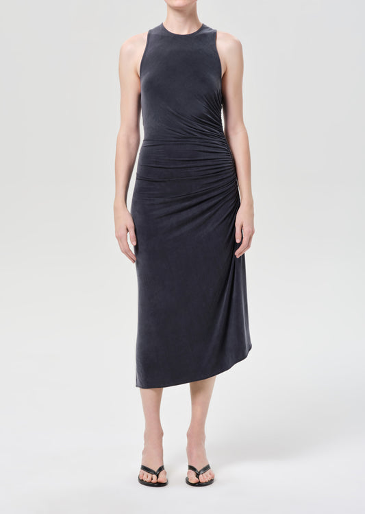 Woman wearing a sleeveless black dress on a white background