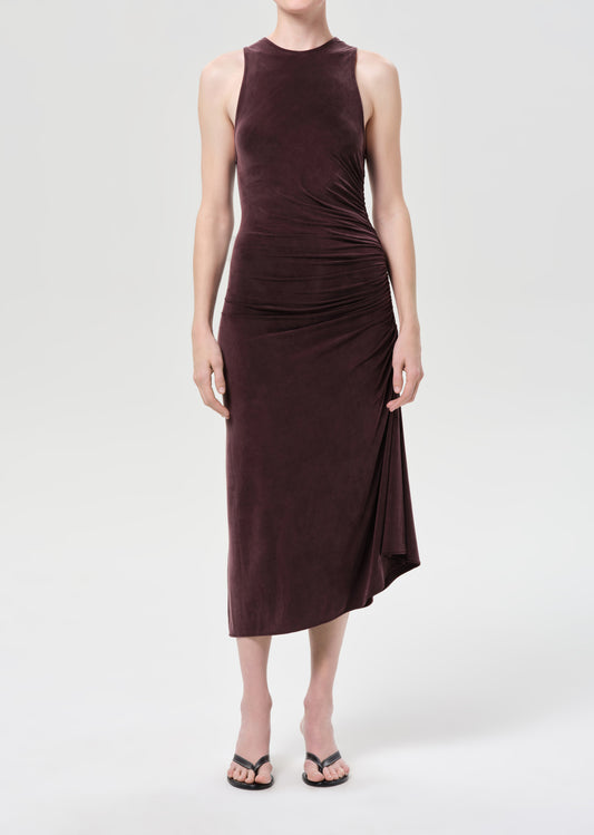 Woman wearing a sleeveless brown dress on a white background