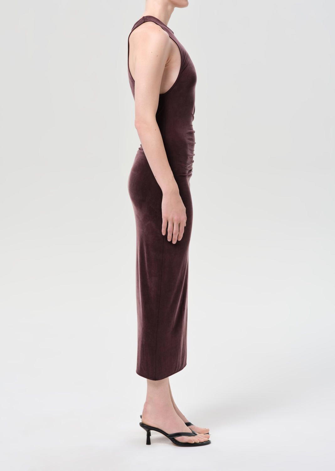 Woman wearing a brown sleeveless dress on a white background