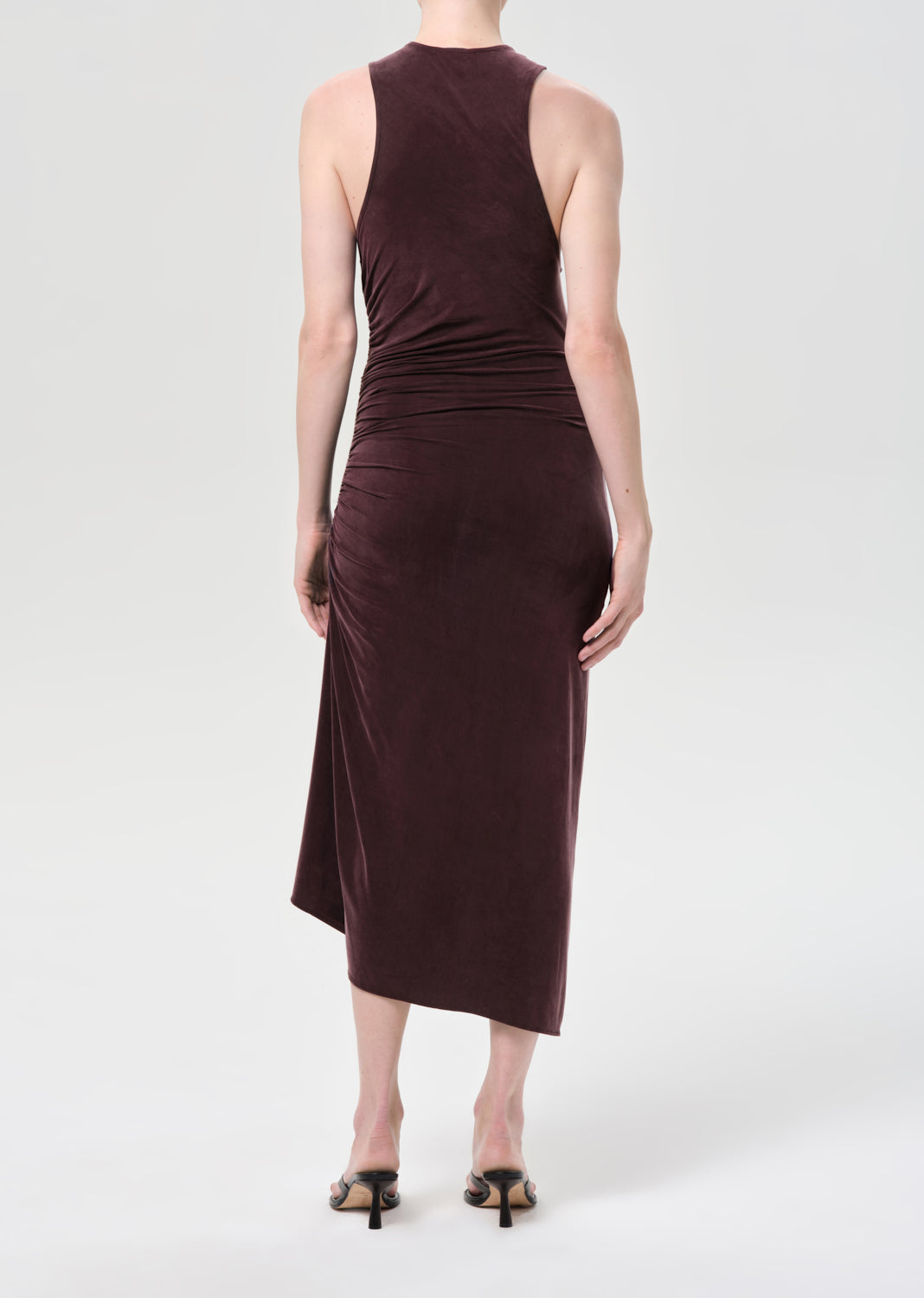 Brown sleeveless dress worn by a person on a white background