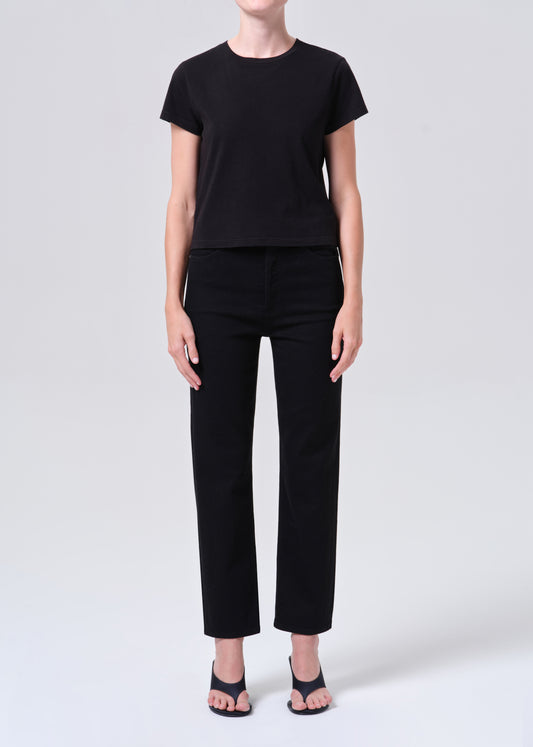 Person wearing a black t-shirt and black pants on a white background