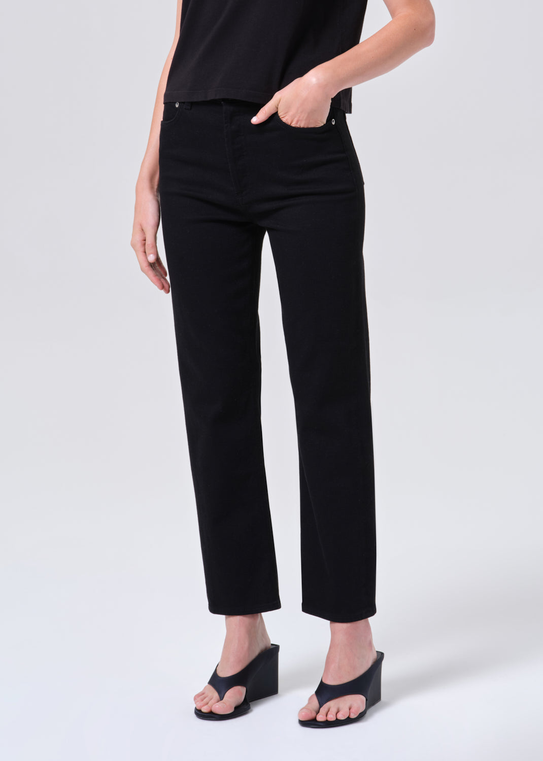 Person wearing black pants on a white background