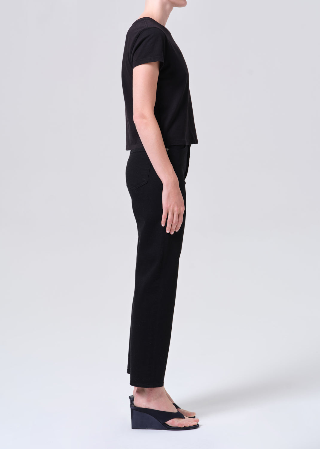 Person wearing a black outfit on a white background