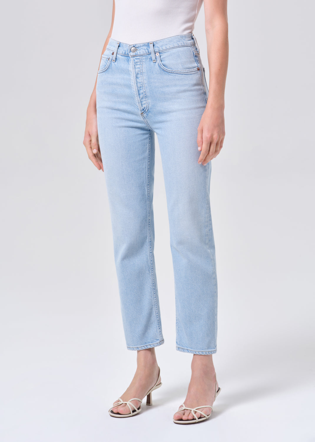 Light blue jeans worn by a person on a white background