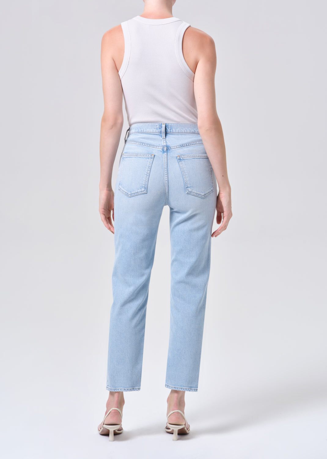 Light blue jeans worn by a person on a white background