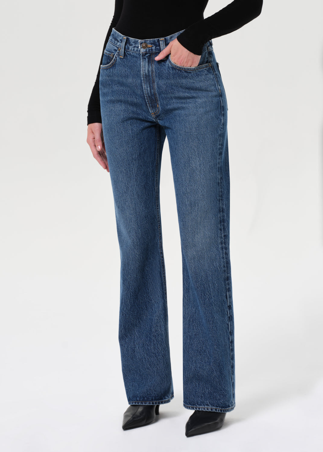 Person wearing blue jeans on a white background