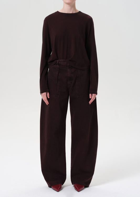 Person wearing a dark brown outfit on a white background