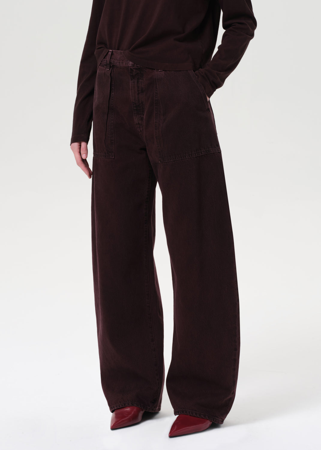 Person wearing brown corduroy pants on a white background
