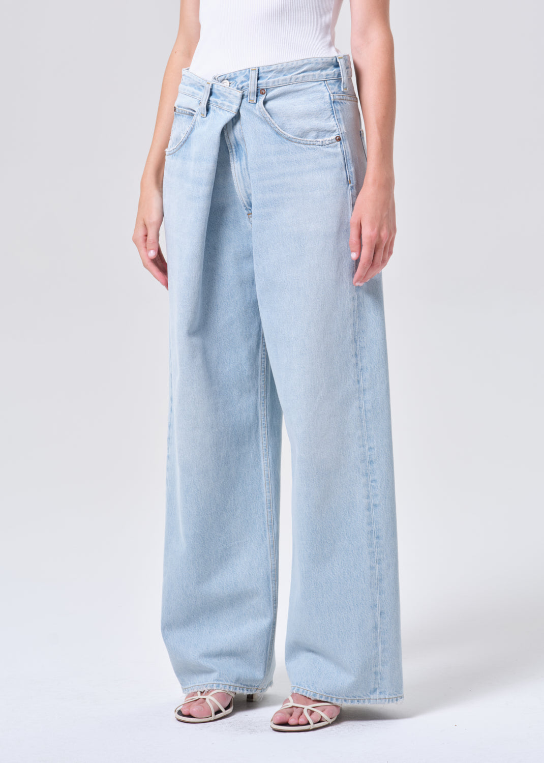 Light blue wide-leg jeans worn by a person on a white background