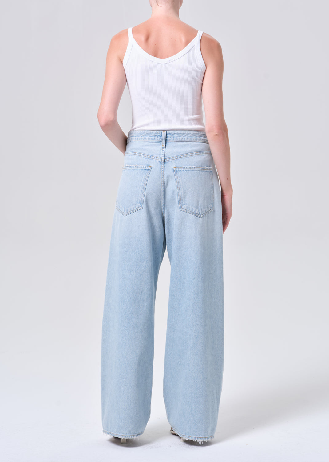 Light blue jeans worn by a person on a white background