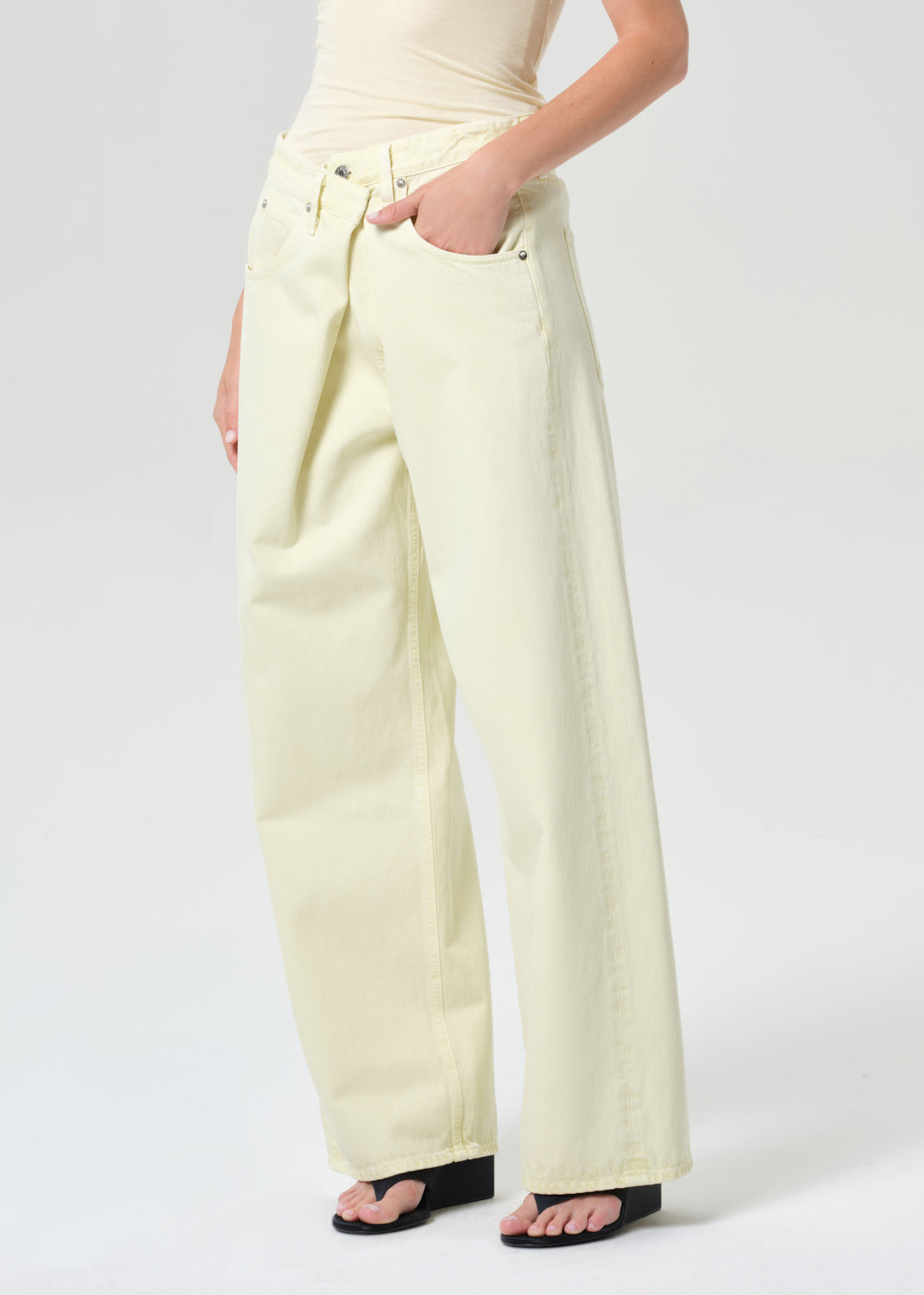 Person wearing light-colored pants on a white background