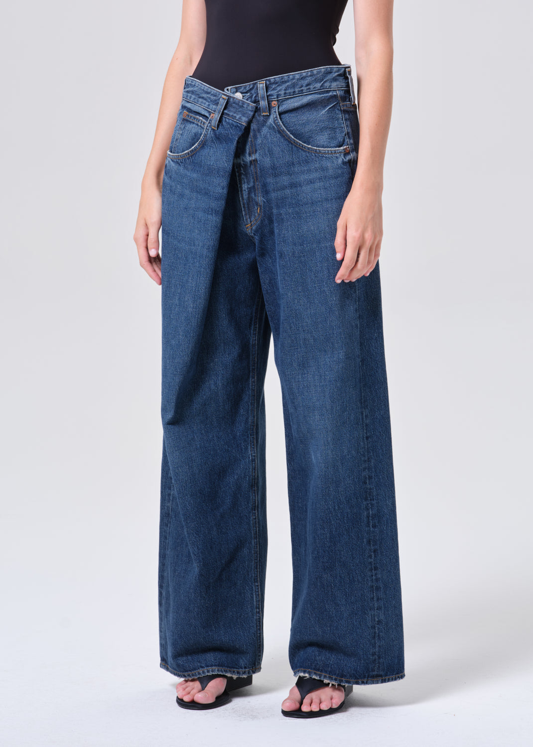 Person wearing blue jeans on a white background