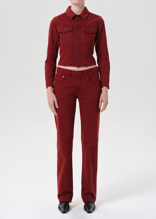 Person wearing a red jacket and pants on a white background