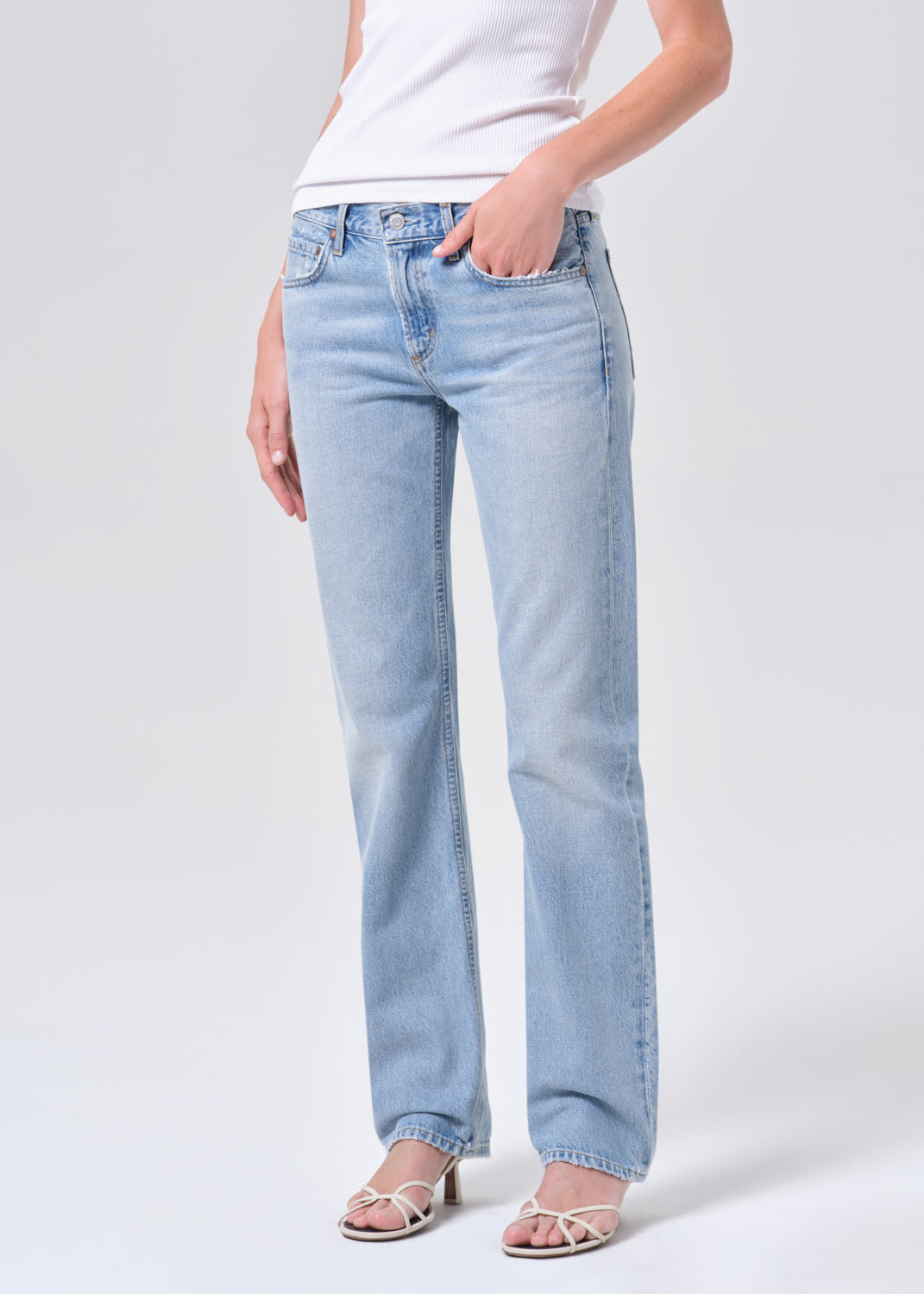 Light blue jeans worn by a person on a white background