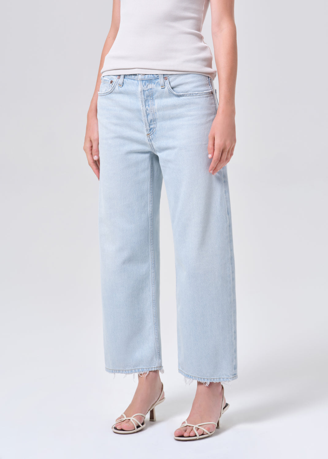 Light blue jeans worn by a person on a white background