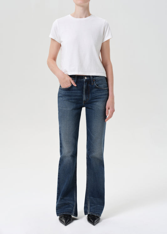 Person wearing a white t-shirt and blue jeans on a white background