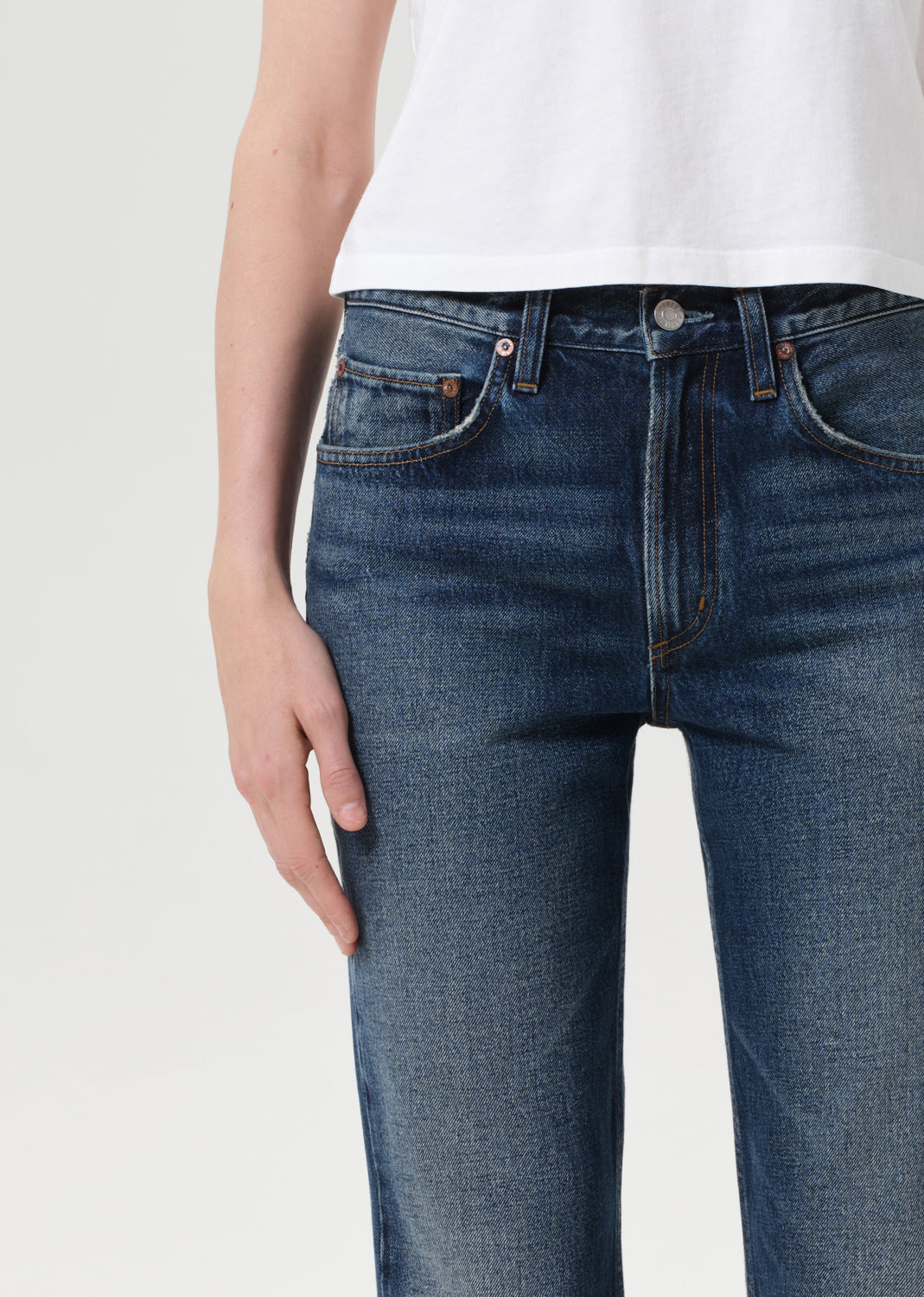Blue jeans worn by a person on a white background