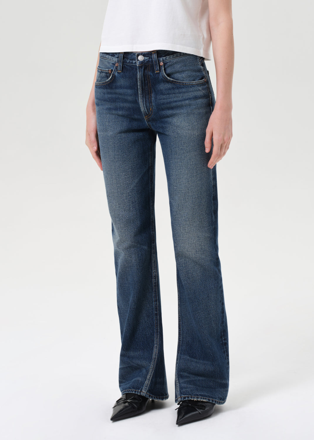 Person wearing blue jeans on a white background