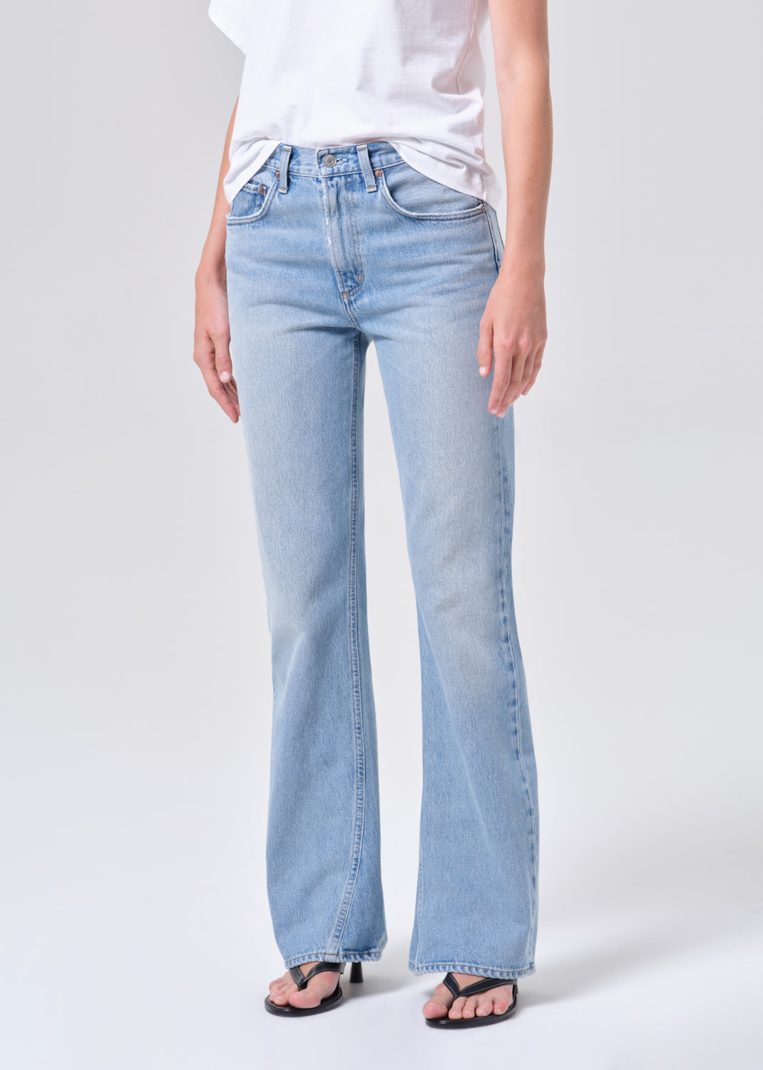 Light blue jeans worn by a person on a white background