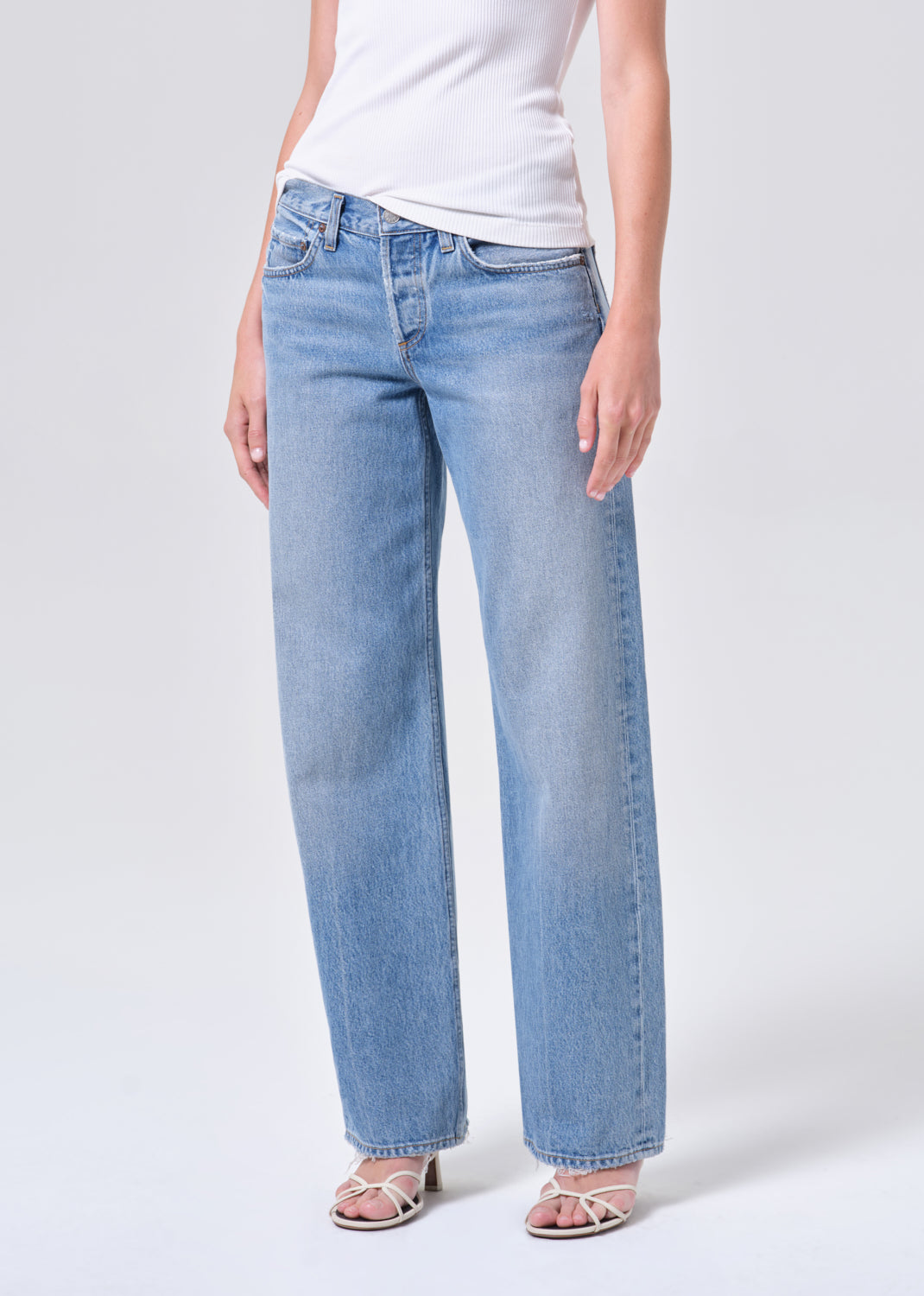 Light blue jeans worn by a person on a white background