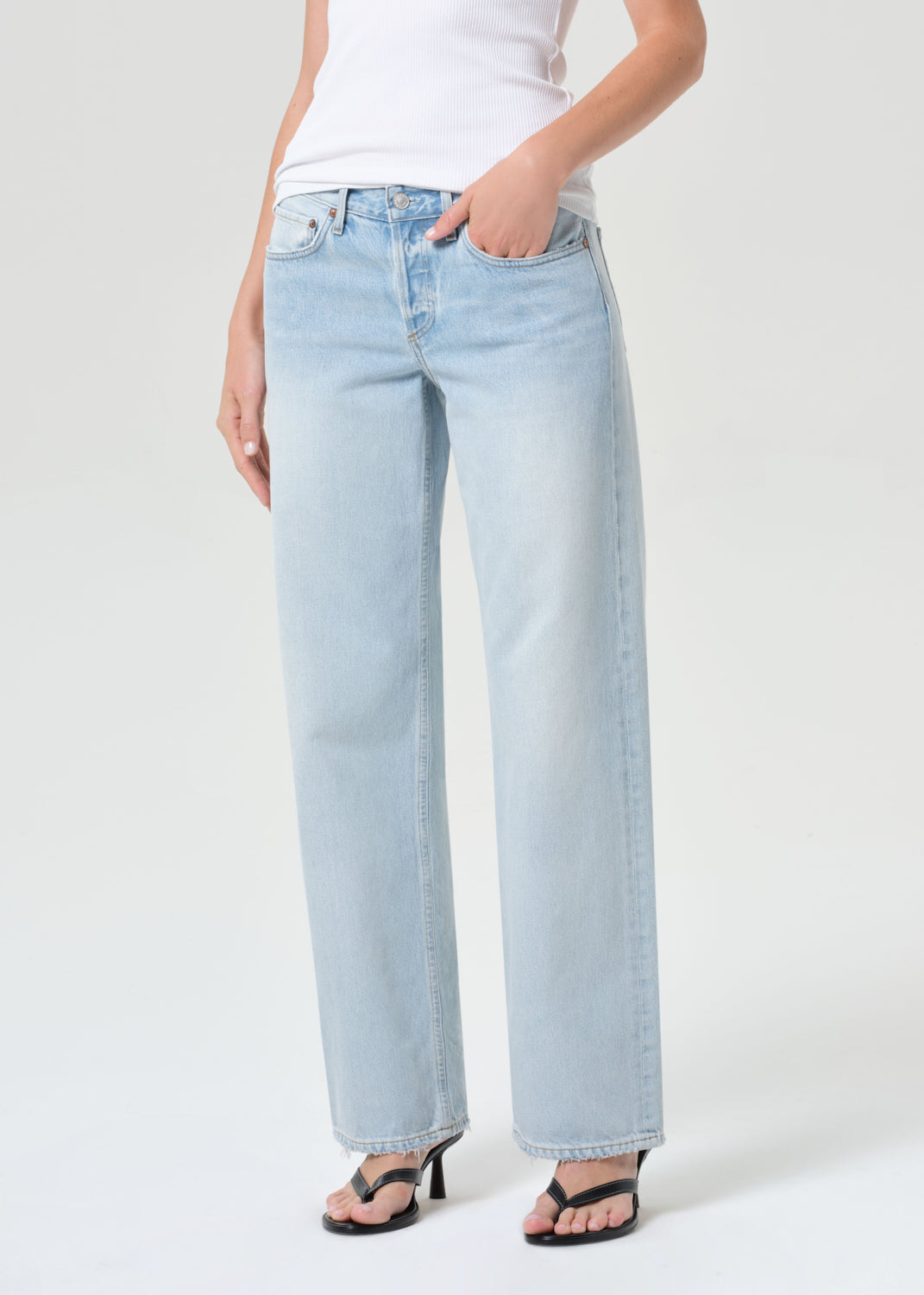 Light blue jeans worn by a person on a white background