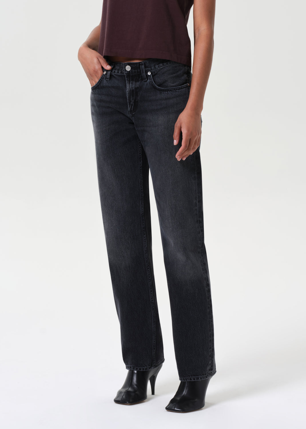 Person wearing black jeans on a white background