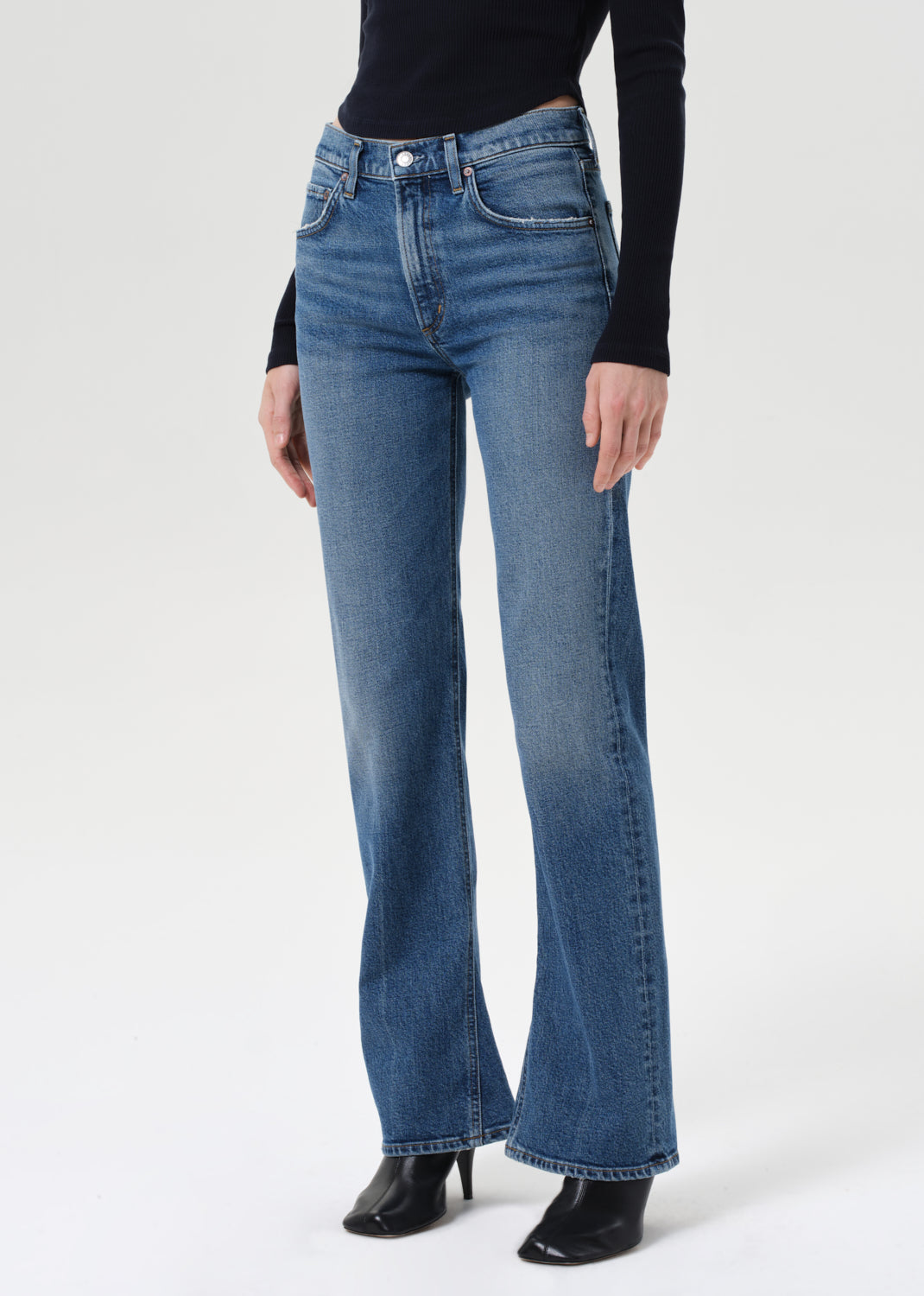Person wearing blue jeans on a white background
