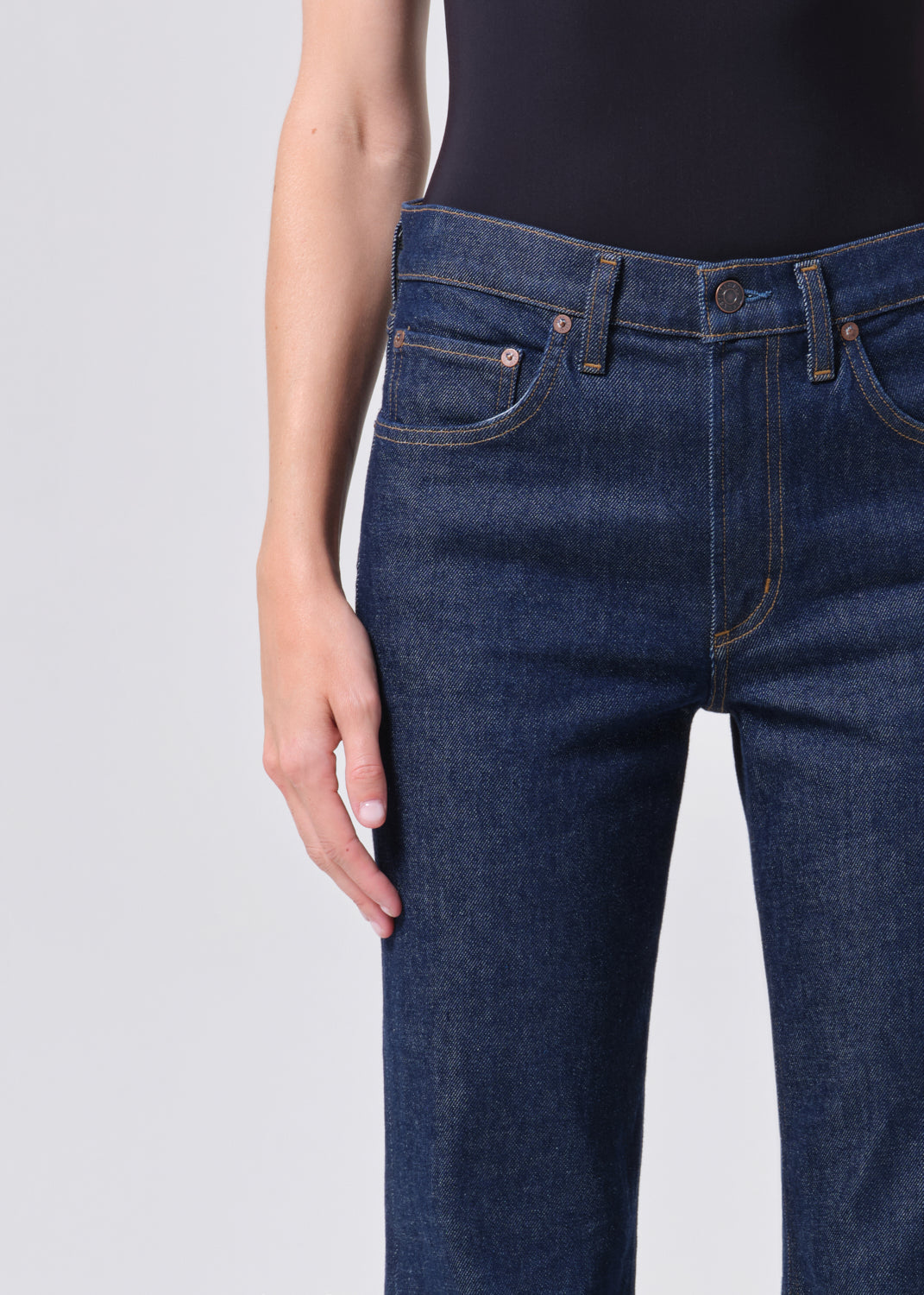 Close-up of dark blue jeans on a plain background