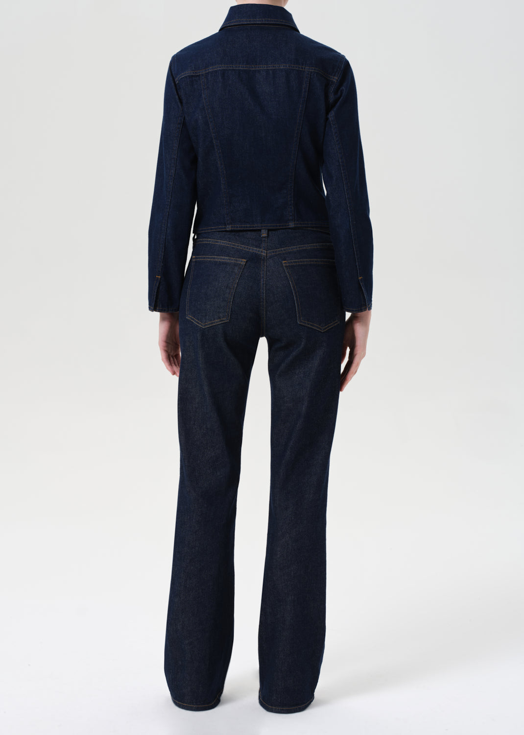 Dark denim jacket and jeans on a white background