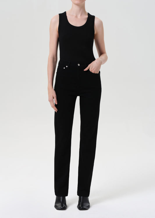 Person wearing a black sleeveless jumpsuit on a white background