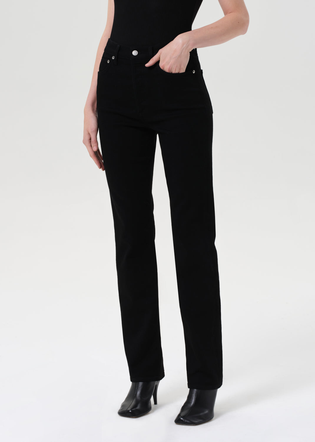 Person wearing black pants on a white background