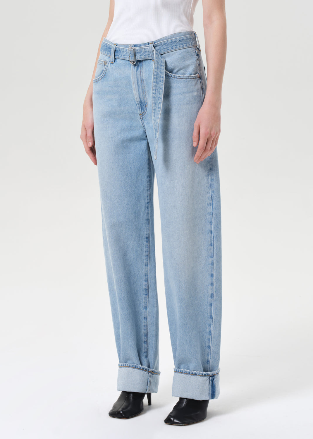Light blue jeans worn by a person on a white background