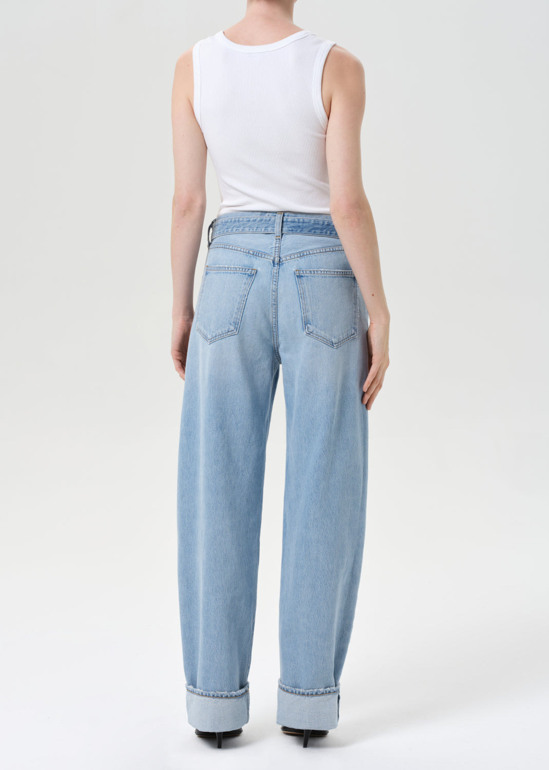 Light blue jeans worn by a person on a white background
