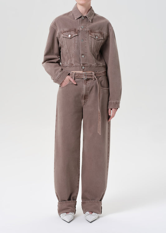Person wearing a brown jumpsuit on a white background
