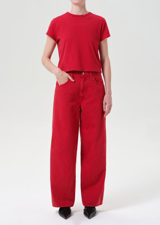 Person wearing a red t-shirt and red pants on a white background