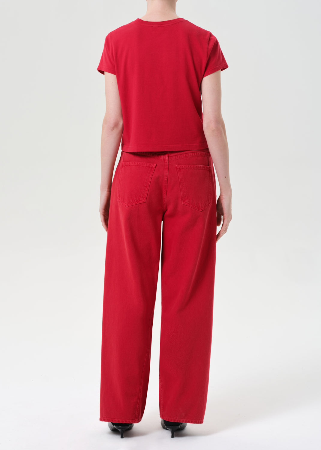 Person wearing a red outfit on a white background
