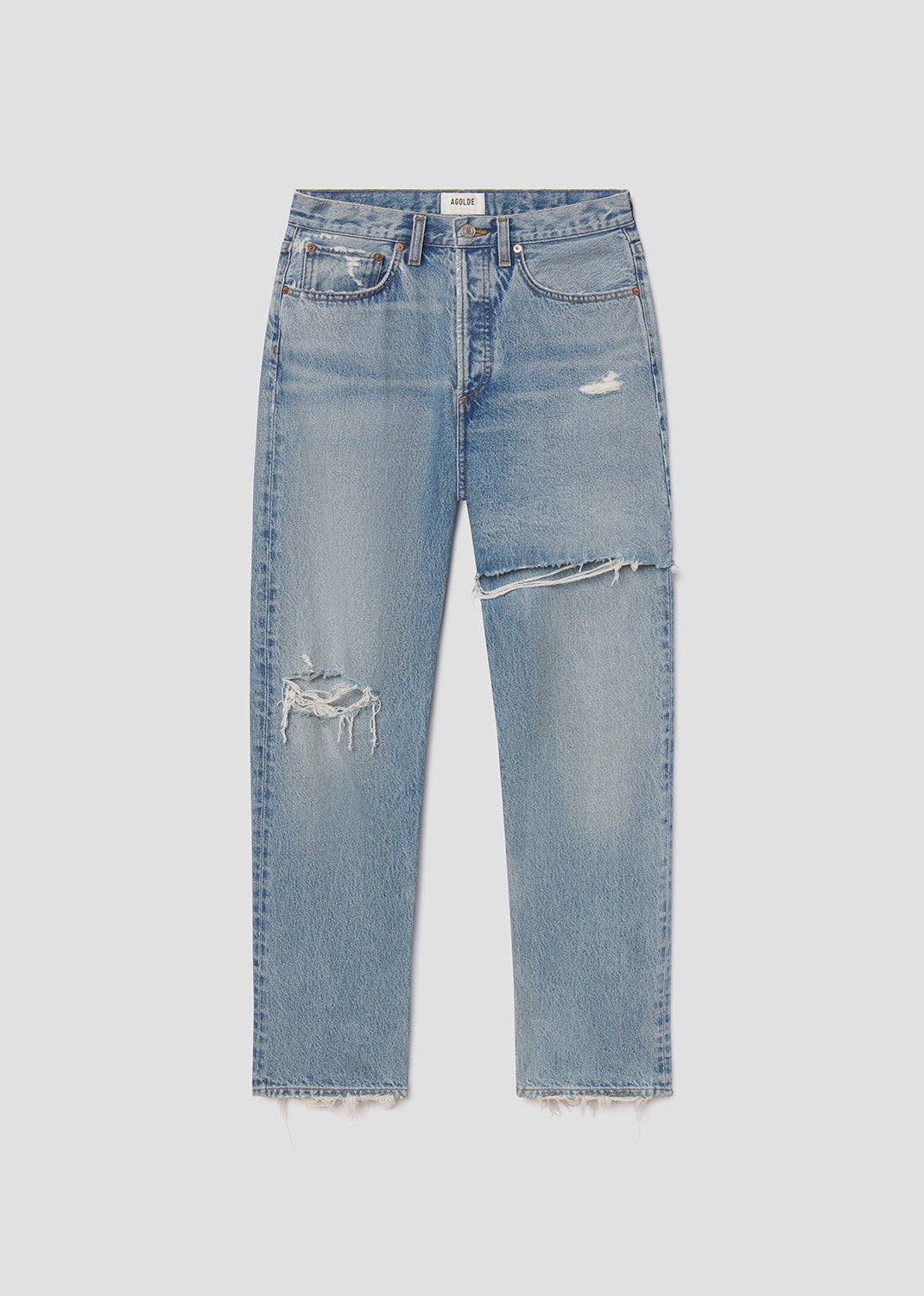 Blue jeans with slight distressing on a light gray background