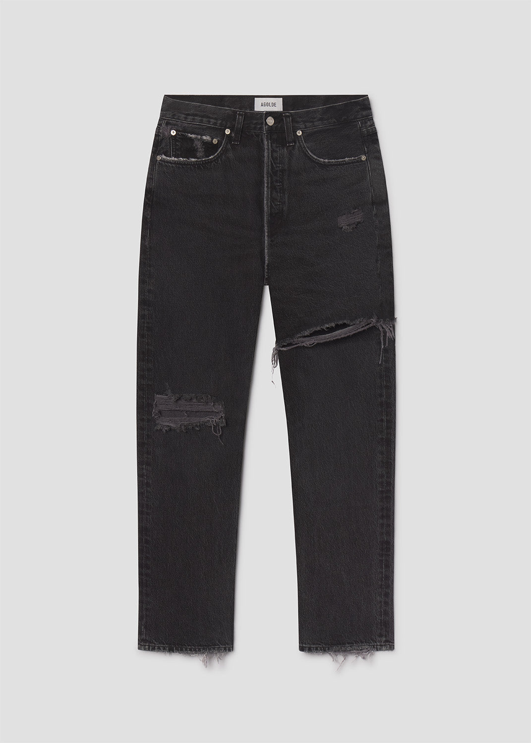 Black distressed jeans on a light gray background