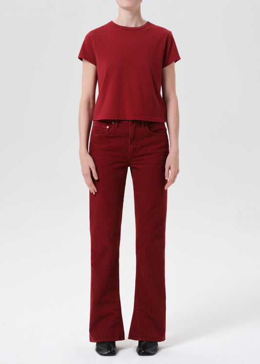 Person wearing a red t-shirt and red pants on a white background