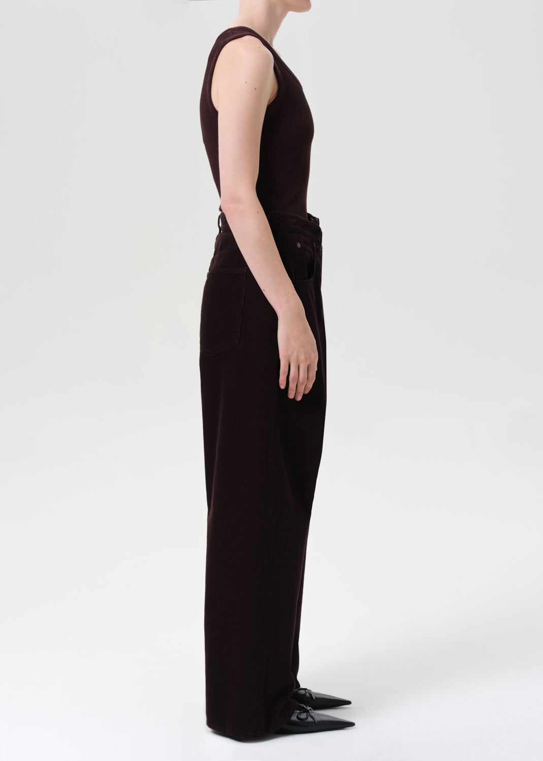 Person wearing a long black dress on a white background